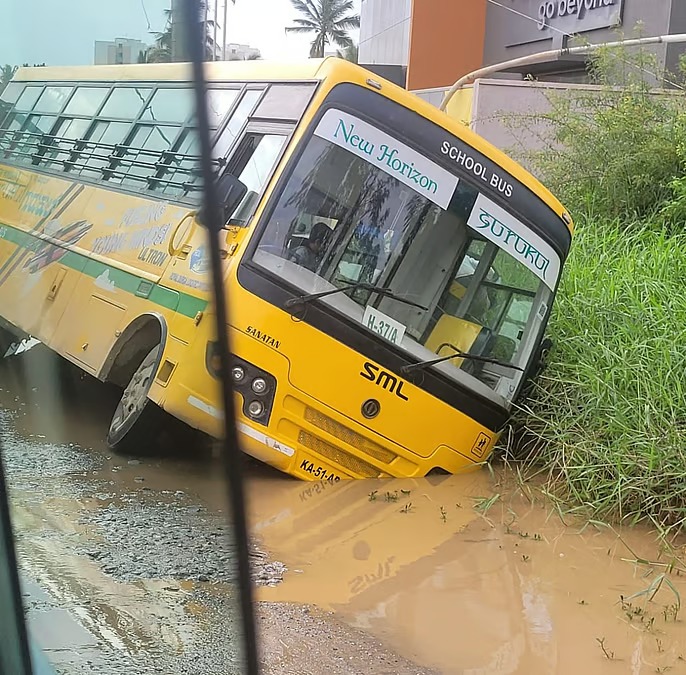 School bus stuck in a drain in Bengaluru, students being rescued
