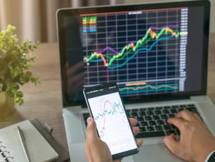 Investor analyzing volatile stock market trends on laptop