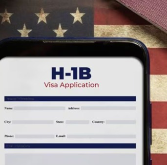 Indian IT professional working on a laptop, considering US H-1B visa opportunities