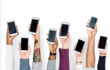 Person holding a smartphone with EMI loan documents, representing rising smartphone loan defaults in India.