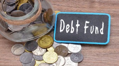 Investor analyzing debt fund performance charts as rising bond yields signal a comeback for fixed-income investments.