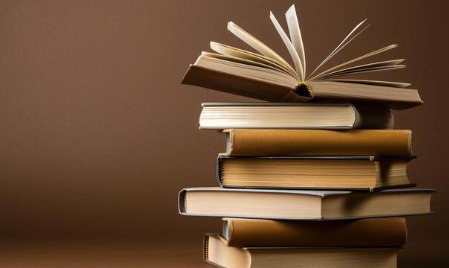 Stack of Indian personal finance books for saving money and building wealth.