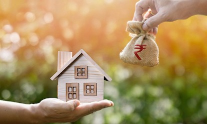 A person checking EMI calculator on a laptop after an RBI rate change announcement.