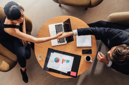 A small business owner reviewing finances and applying for a working capital loan online.