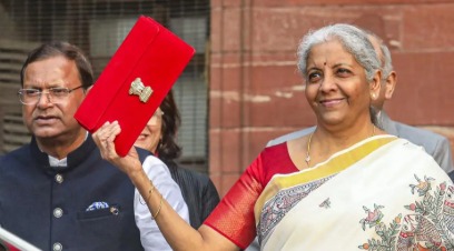 A middle-class Indian family reviewing loan documents and budget highlights for 2025.