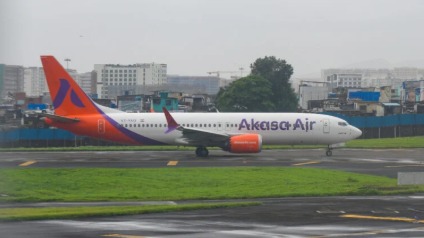 Akasa Air Boeing 737 Max 8 on tarmac with technicians inspecting engine after bird strike