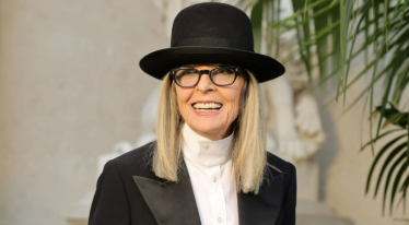 Diane Keaton smiling at a film premiere, remembered as an Academy Award-winning Hollywood legend