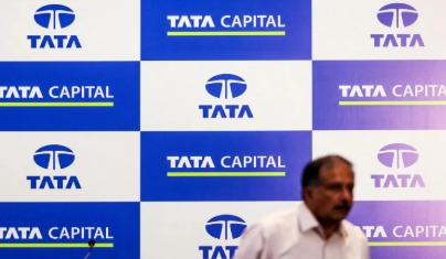 Businessperson reviewing Tata Capital loan documents with a laptop