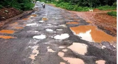 Damaged highway with potholes symbolizing Karnataka-Andhra dispute