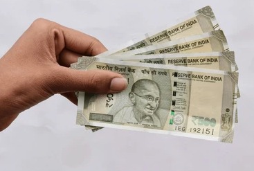 Indian Rupee currency notes with upward graph representing currency appreciation