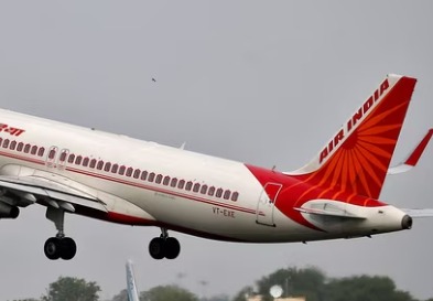 Air India aircraft at airport with GIFT City skyline background