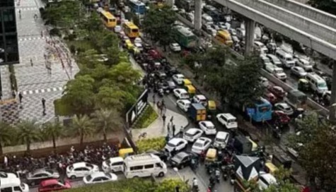 Aerial view of Bengaluru with new business corridor marked, showing reduced traffic flow.