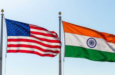 Indian and U.S. flags with oil barrels symbolizing energy diplomacy.