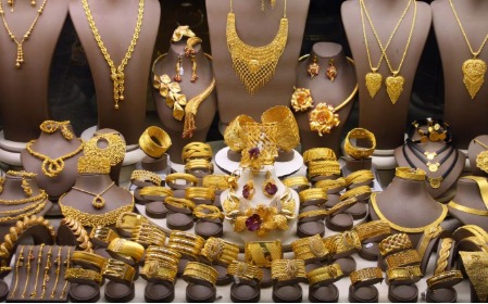 Gold jewelry and coins with hallmark stamps for Diwali shopping 2025.