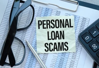 Person reviewing loan documents with warning signs of personal loan fraud.