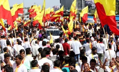 Karnataka government office with protest banners and RSS symbols, representing suspension controversy.