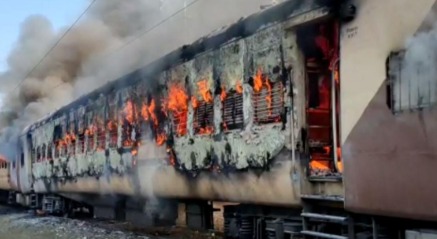 Fire breaking out in a passenger train in Punjab, depicting emergency response.