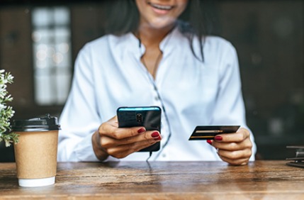 Person using a smartphone to apply for a small-ticket loan during Diwali shopping.