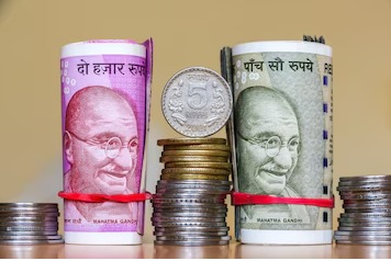 Indian rupee coins and banknotes showing currency fluctuations.