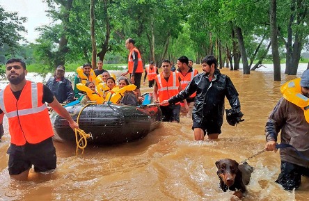 Rescue teams assisting flood-affected families in Karnataka.