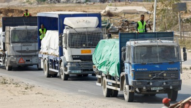 Humanitarian aid trucks preparing to enter Gaza after ceasefire announcement.