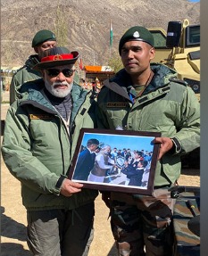 PM Modi lighting a diya during Diwali celebrations in Kargil.