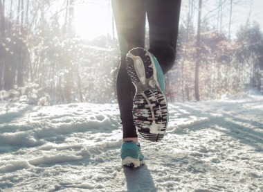 Person performing deep breathing exercises outdoors in winter.