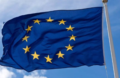 EU flags waving over a natural gas terminal in Europe.