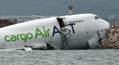 A cargo plane skidding off the runway at Hong Kong International Airport and crashing into the sea.