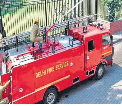 Delhi Fire Services team responding to Diwali fire emergency, city lights and fireworks in background — 269 calls managed safely
