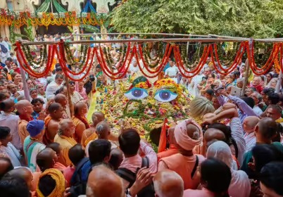 Devotees offering Annakut and performing Govardhan Puja rituals in front of Lord Krishna idol