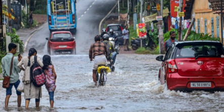Heavy rainfall in Kerala with flooded streets and dark clouds, IMD issues red and orange alerts