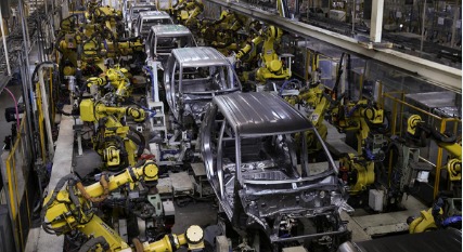 Indian manufacturing factory floor with workers assembling electronics under PLI scheme funding