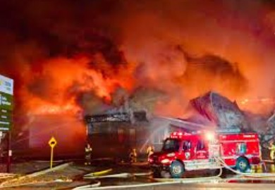 Firefighters extinguishing a residential building fire in Ghaziabad, evacuating families safely