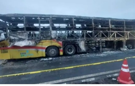 Burnt Hyderabad-Bengaluru bus with fire rescue personnel at the scene