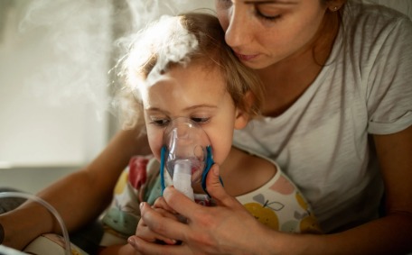 Patients receiving nebulizer treatment in Delhi hospital.