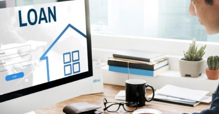 A loan officer reviewing unsecured loan applications at a finance company.