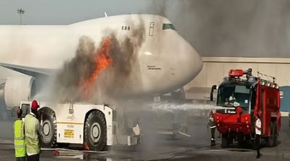 Firefighters extinguishing burning bus near Air India aircraft at Delhi Airport T3