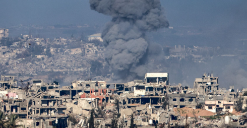 Aerial view of damaged buildings in Gaza following airstrike during ceasefire period.