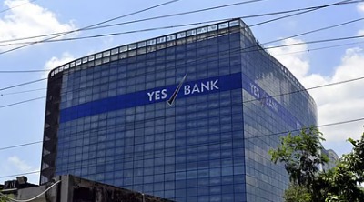 CBI headquarters building with Yes Bank logo and Anil Ambani’s silhouette in background symbolizing financial investigation