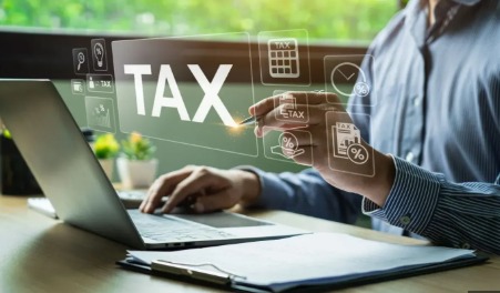 Tax professionals reviewing financial documents with a calendar highlighting the extended tax audit deadline for FY 2024–25