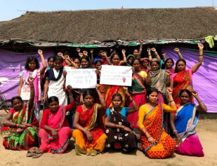 Rural Indian women standing outside village houses symbolizing justice gap and superstition-related violence