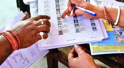 Indian citizens verifying voter rolls during election registration drive in India