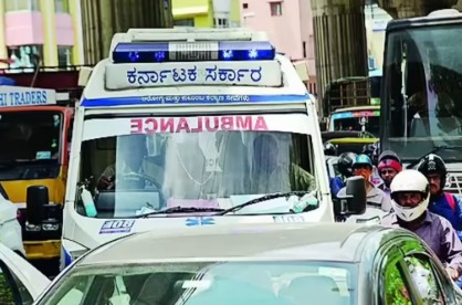 A damaged scooter and ambulance at a traffic junction in Bengaluru after a fatal accident caused by a red signal violation