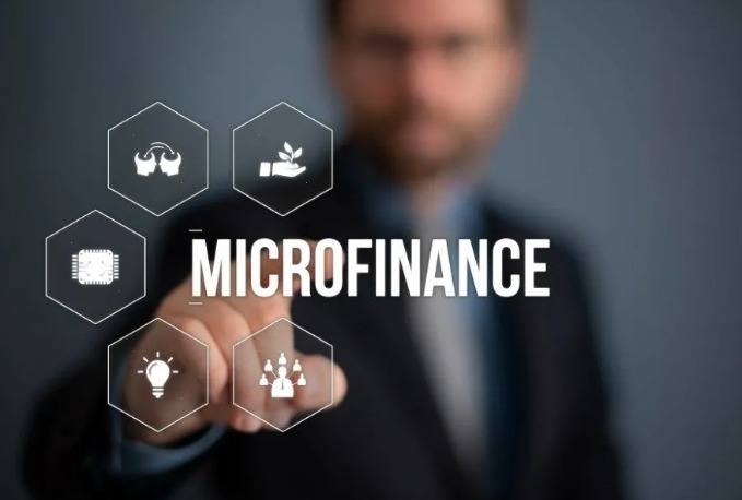 Rural women attending a microfinance meeting in India, symbolizing small-ticket loan stress in 2025.