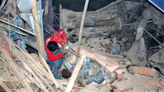 "Residents and rescue workers inspecting damaged buildings after earthquake in Afghanistan"