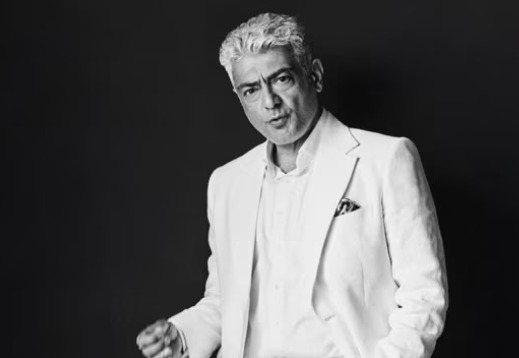 “Ajith Kumar smiling in Dubai relocation interview”