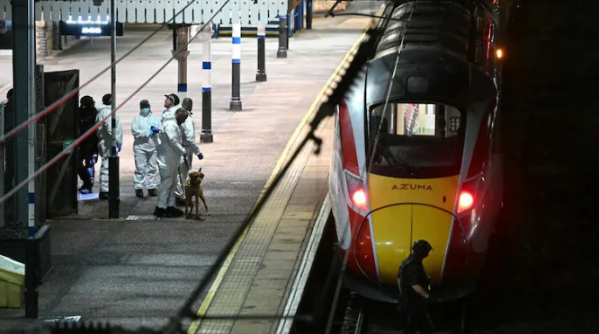 Police officers conducting investigation after UK train stabbing incident.