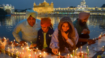 Devotees at a gurdwara lit up at night during Guru Nanak Jayanti celebrations