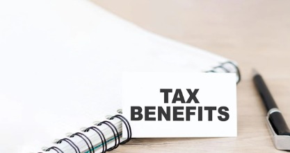 A professional calculating tax savings from a personal loan with financial documents on a desk